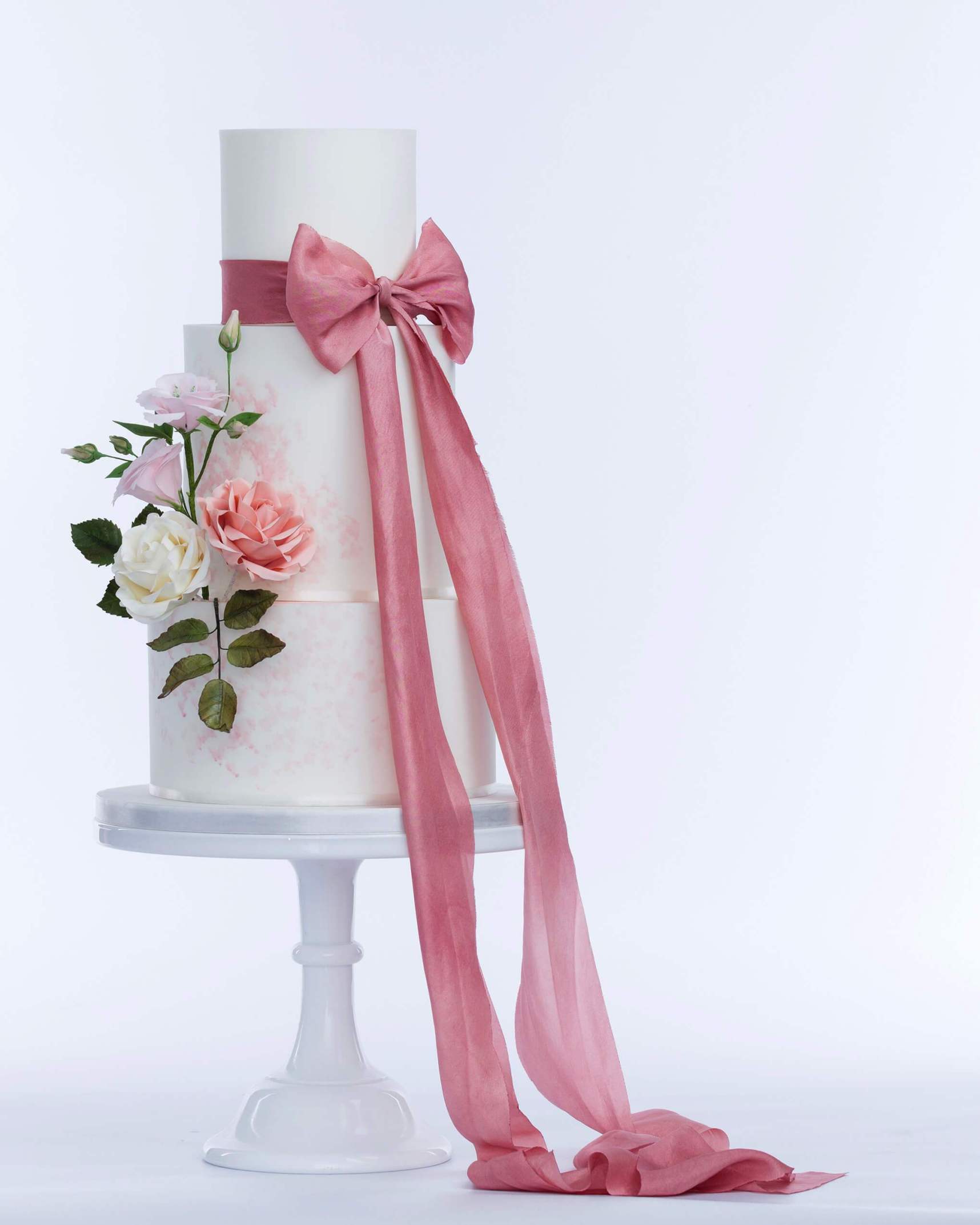3 tiered wedding cake with a ribbon