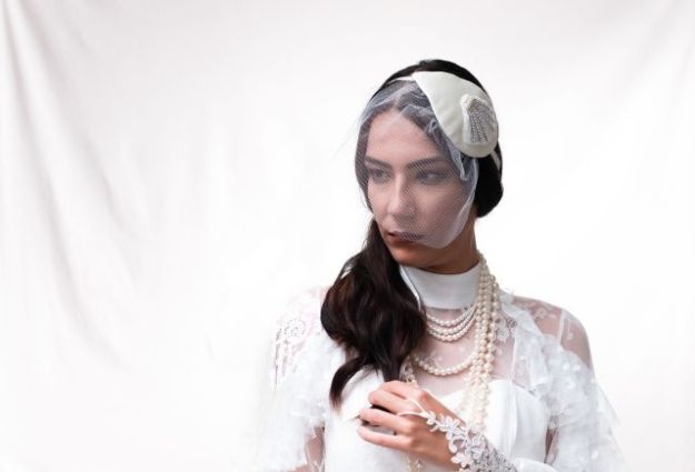 Teardrop shape Ivory wedding fascinator hat with birdcage veil