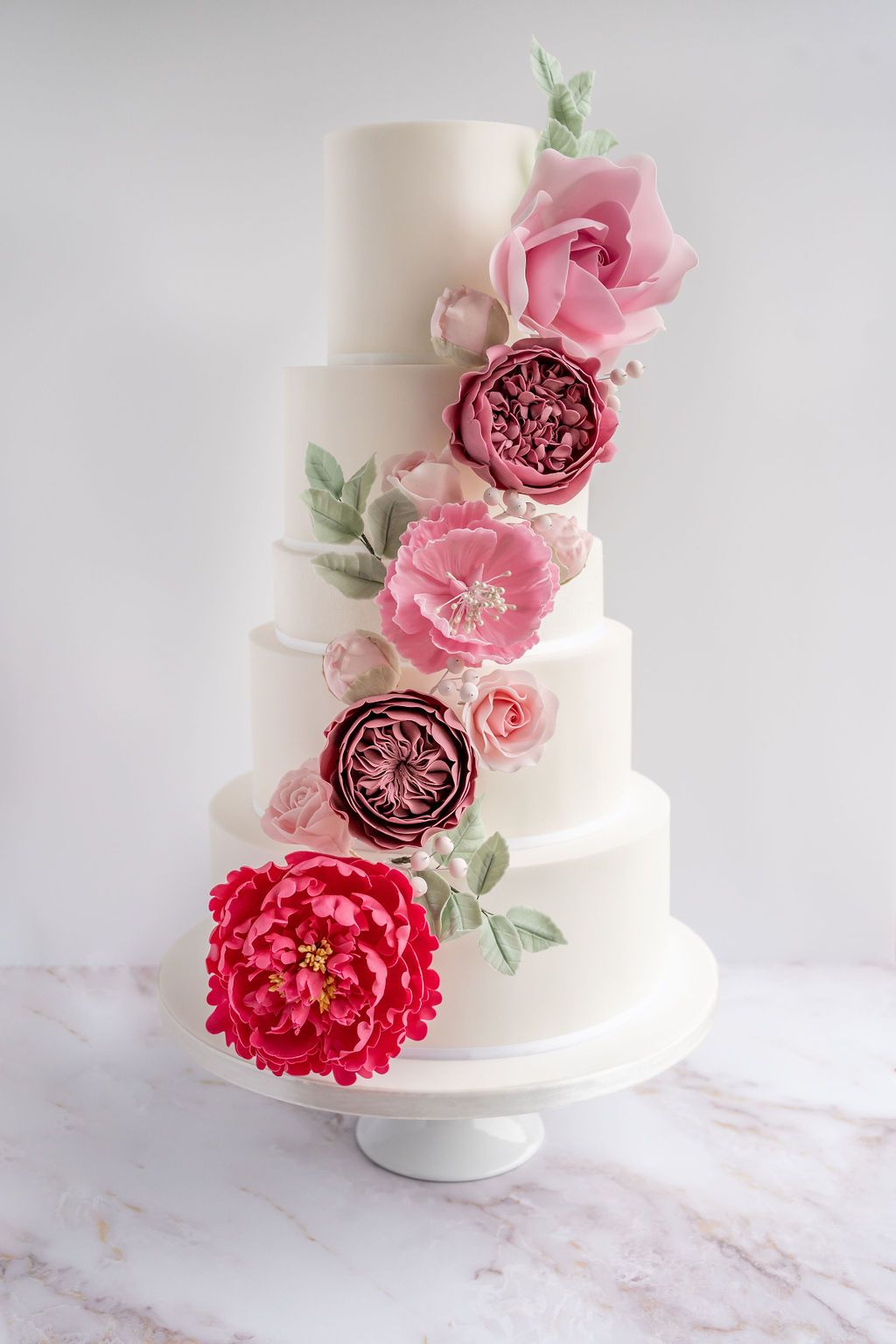 4 tier wedding cake with real looking sugar flowers